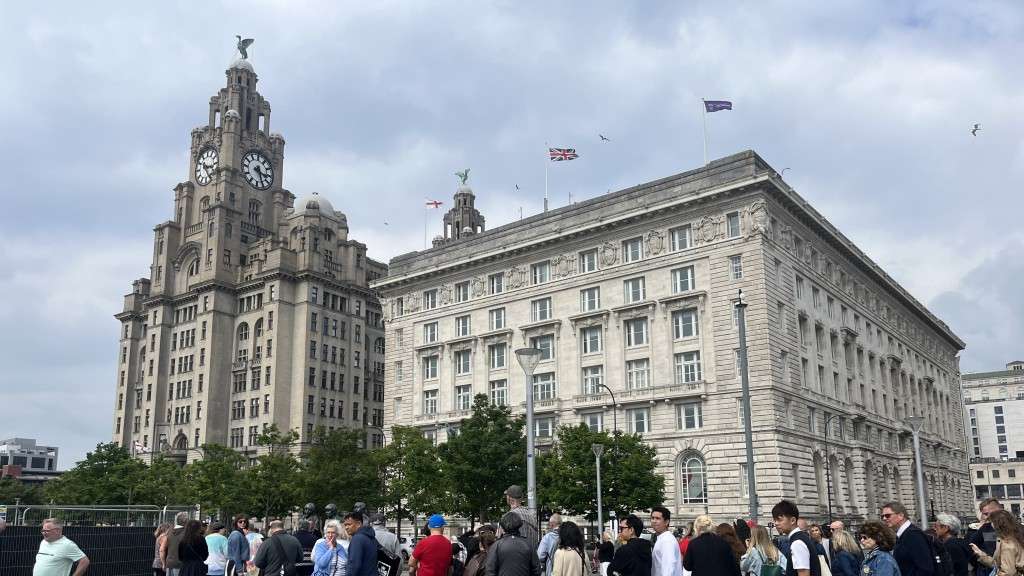 Fans at the Beatles statue outside the Cunard Building [Credit: Jonathan Brown]